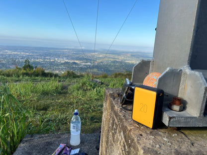 Bottle and yellow device on a concrete structure with a scenic view in the background